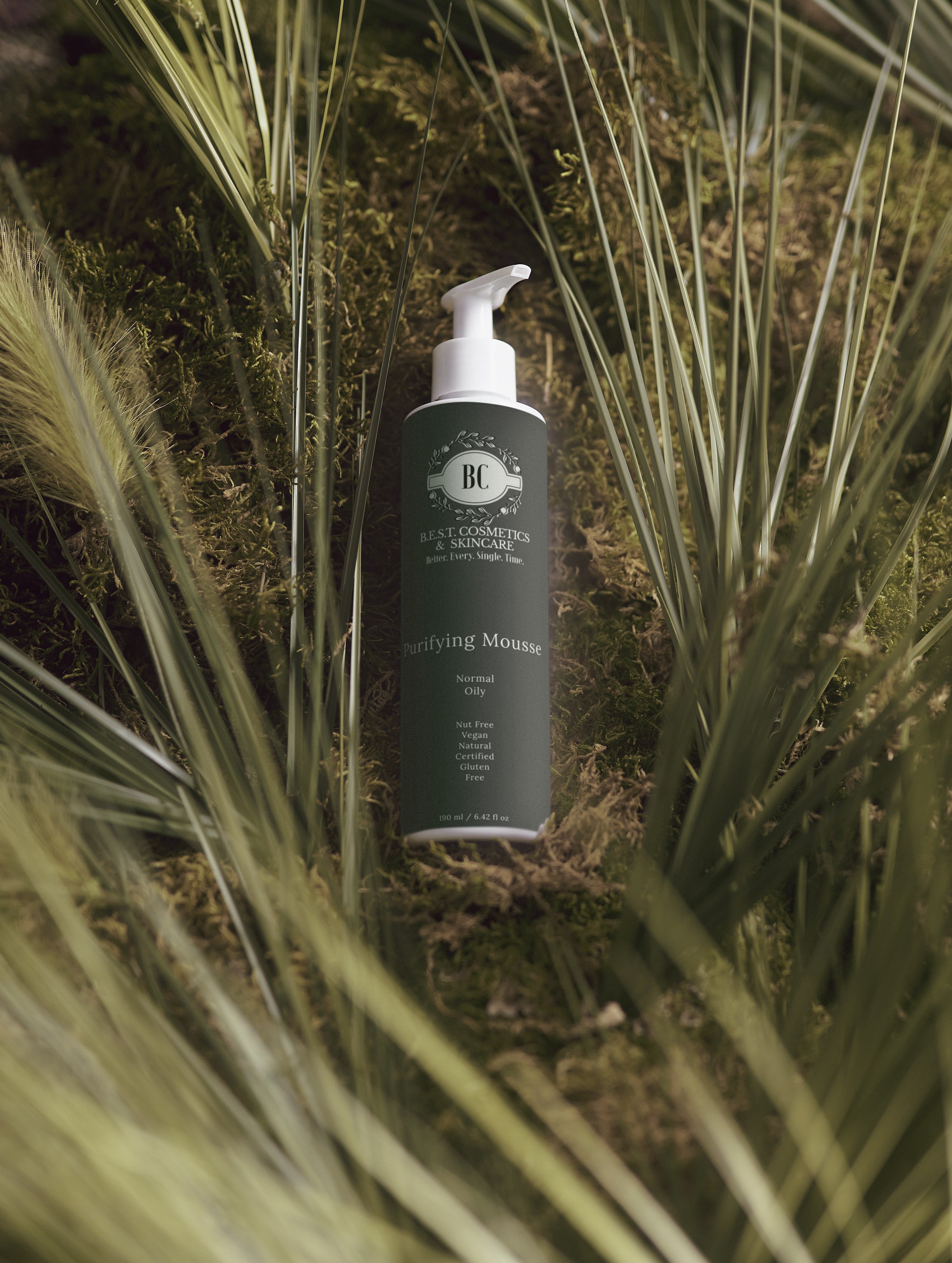 Bottle of hair care product with brand logo on grass