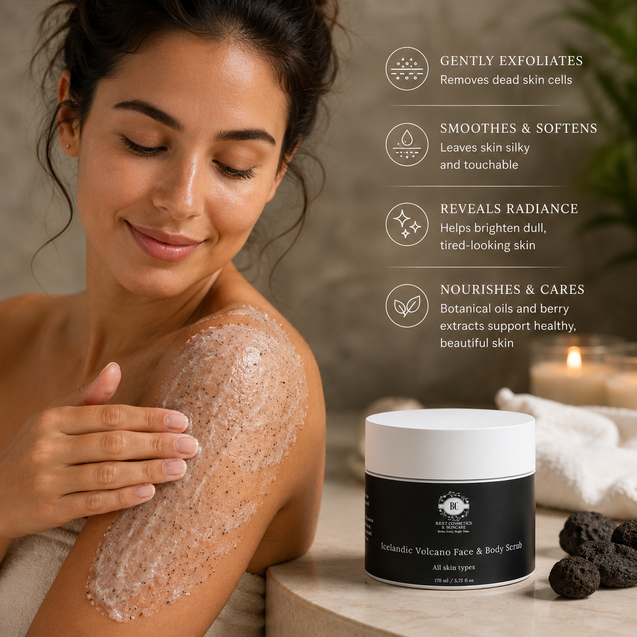 In a serene, softly lit bathroom setting, a young woman smiles gently as she massages a creamy exfoliating scrub onto her dewy shoulder, her relaxed expression glowing under warm, calming light. The black jar of "BC Icelandic Volcano Face & Body Scrub" sits on a light stone counter nearby, highlighted by elegant text detailing its exfoliating, smoothing, radiance-boosting, and nourishing benefits in crisp white typography.