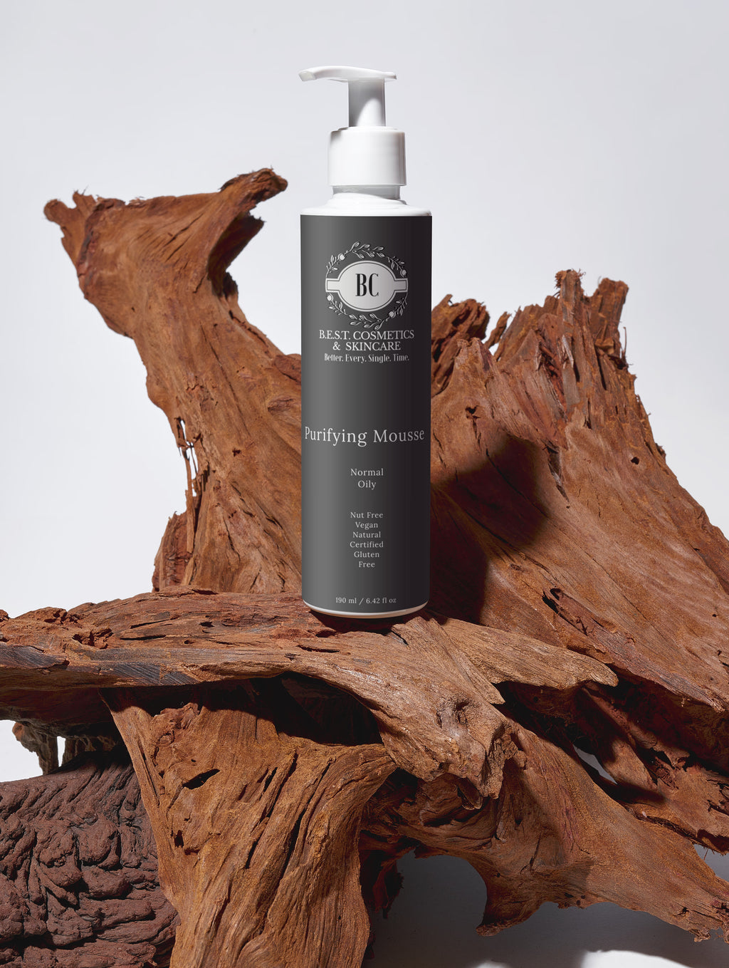 B.E.S.T. Cosmetics & Skincare Purifying Mousse bottle on a wooden surface with a neutral background.