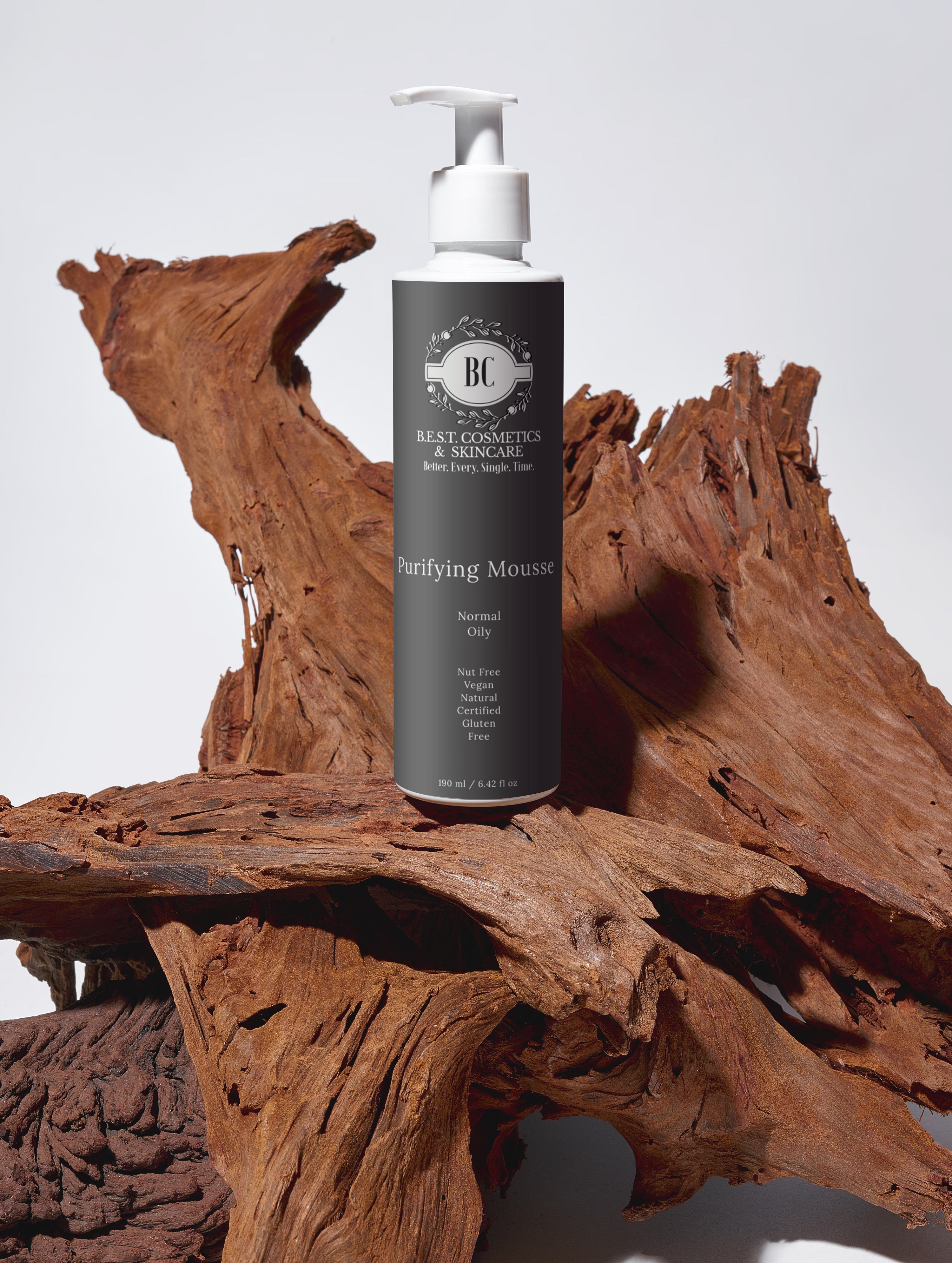 B.E.S.T. Cosmetics & Skincare Purifying Mousse bottle on a wooden surface with a neutral background.