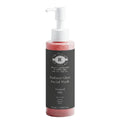 Facial wash bottle with pump on a white background